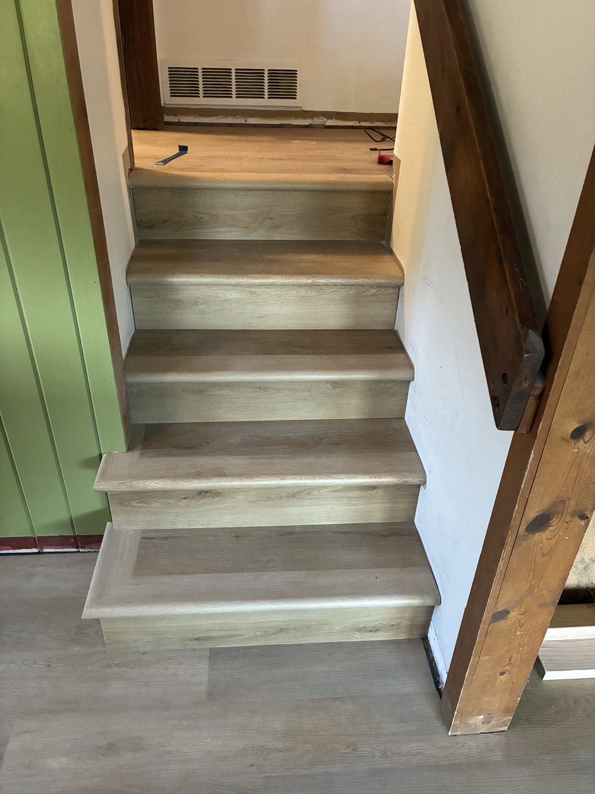 Stair treads wrapped in matching LVP