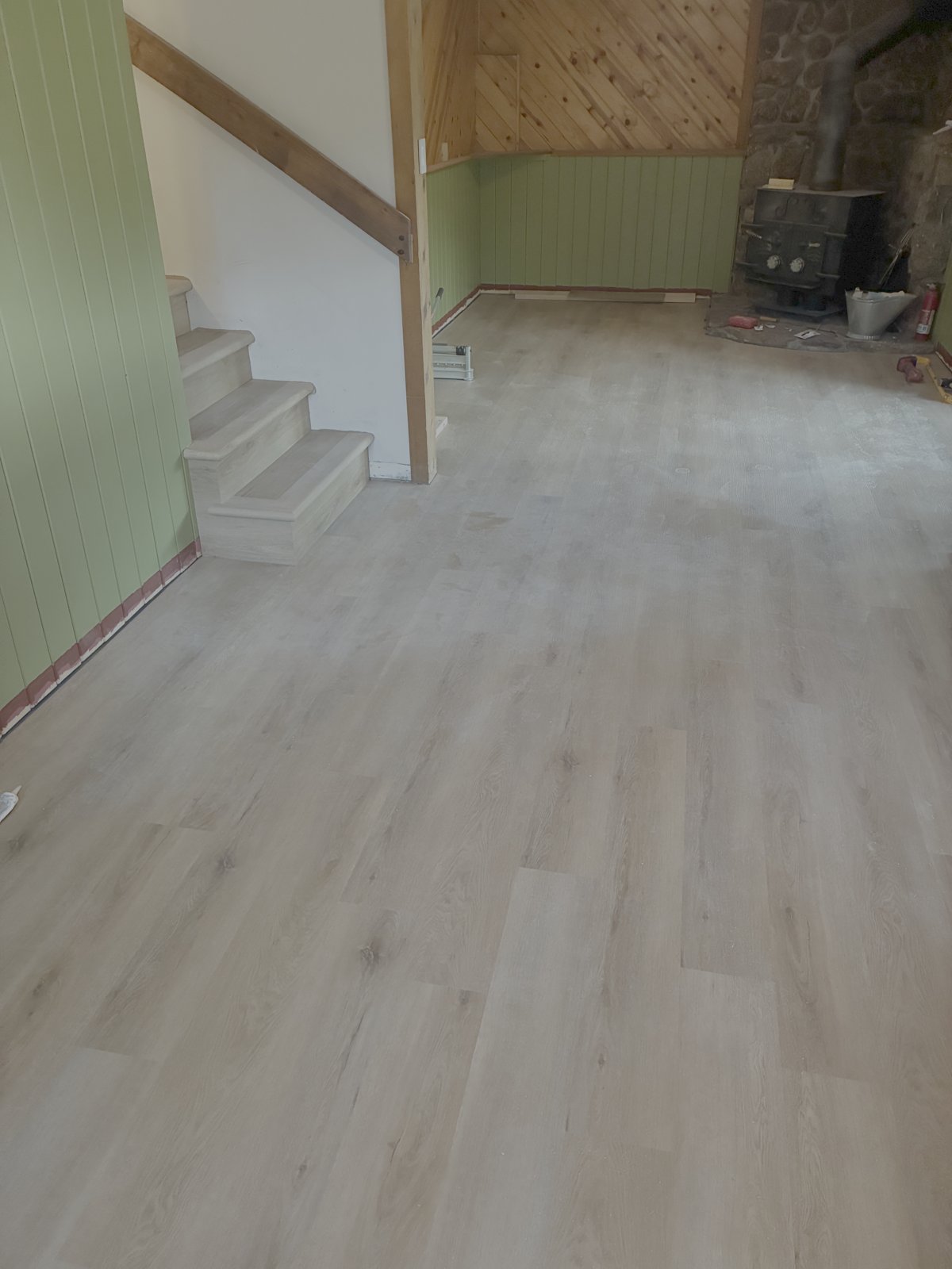 Living room LVP, stairs and wood stove corner