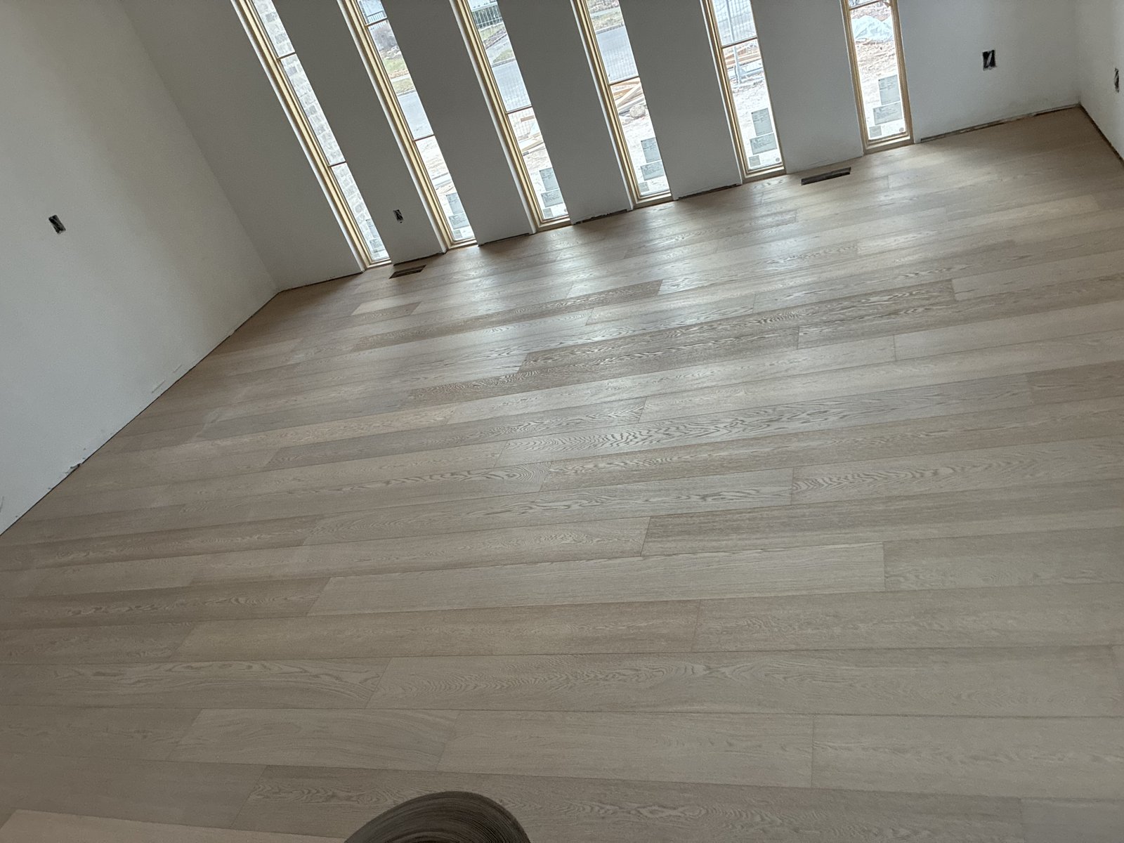 Finished great room — natural light, wide plank